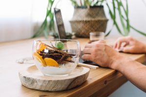 How to recover quickly after heavy drinking and ease hangover symptoms Person with hangover drinking water and eating healthy food for recovery.