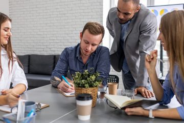 Employees finishing work early on the day before a holiday with colleagues and supervisors in an office environment