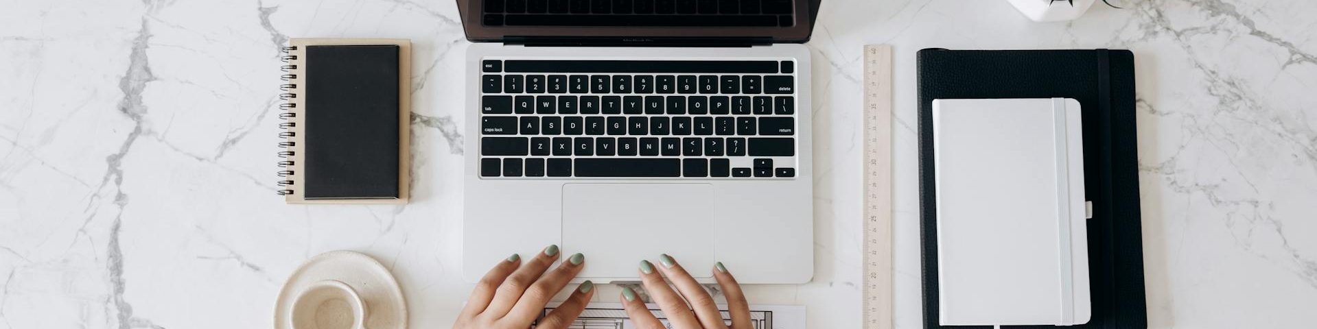 Professional translator working with multilingual documents and laptop, representing translation services