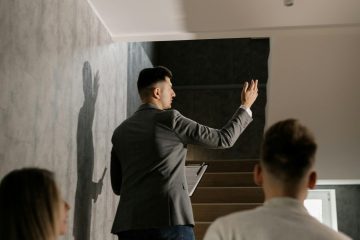 A visually split photo showing a modern suburban house on one side and a sleek urban apartment building on the other, symbolizing the home-buying decision.