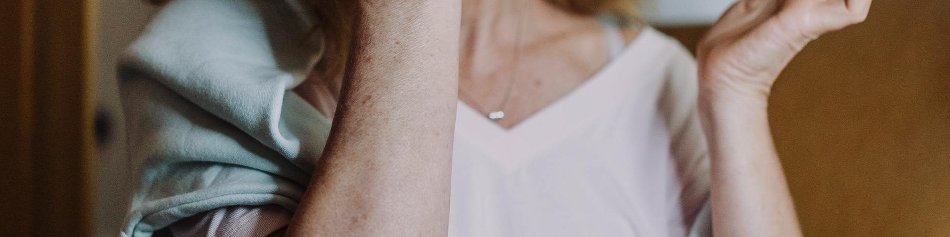 A person calmly planning their day in a bright, modern setting, with elements representing mental clarity, physical health, and personal growth visible on or near their desk.