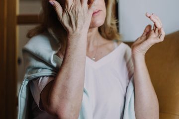 A person calmly planning their day in a bright, modern setting, with elements representing mental clarity, physical health, and personal growth visible on or near their desk.